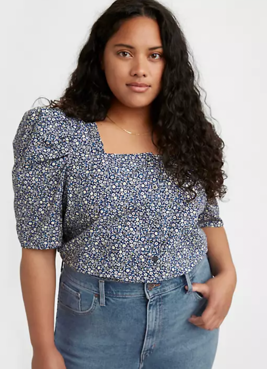 model wearing a blue floral blouse with puff sleeves and a square neck