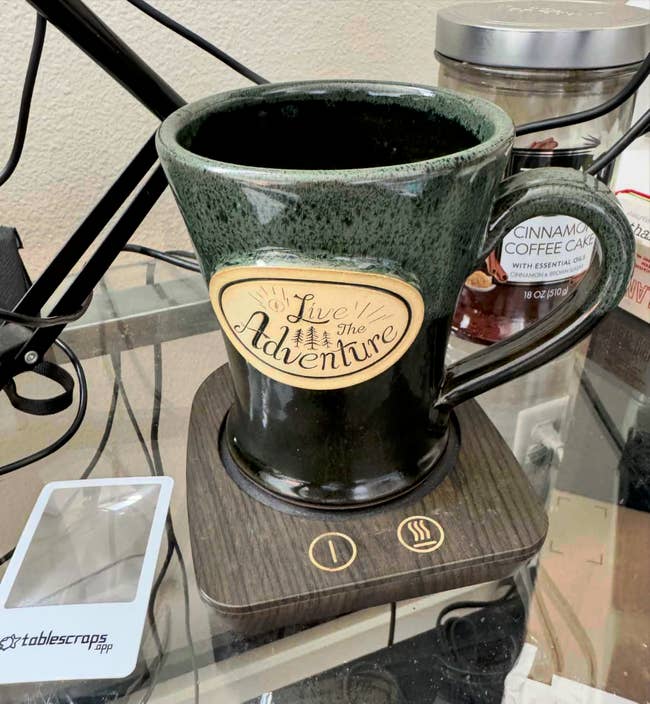 Large ceramic mug connected  a mug warmer with 