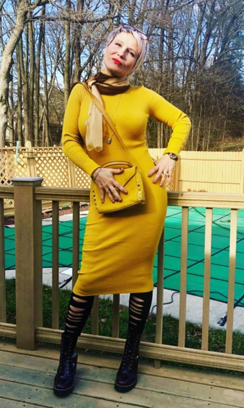 reviewer photo wearing the dress in yellow on a deck