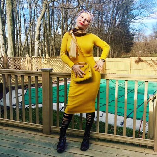 reviewer photo wearing the dress in yellow on a deck