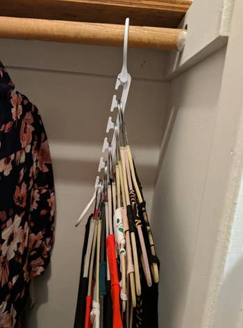 a reviewer photo of the same hanger with the clothes cascading down to save space 