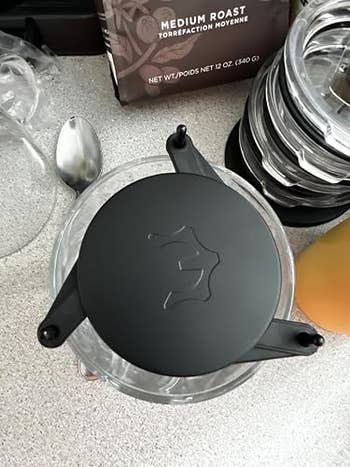 Coffee shaper with sleek plan connected countertop, spoon, and mean roast java bundle successful the background