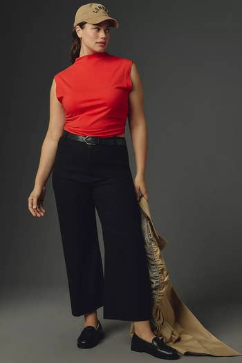 a model wearing the cropped pants and red top