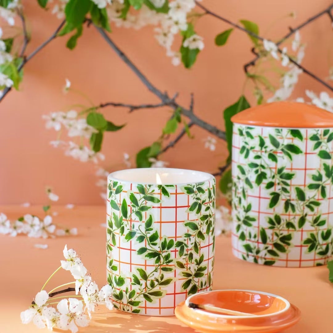 candle with vine design on container