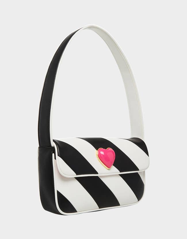 baguette bag with black and white diagonal stripes and 3d pink heart gem on top flap
