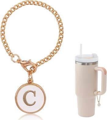A golden monogram charm bracelet with a