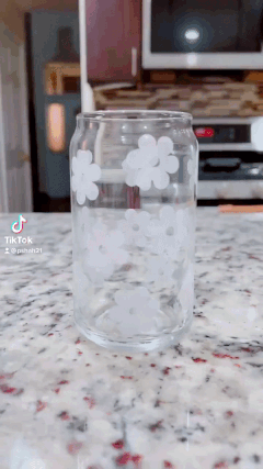 gif of cold water being poured into the cup and the flowers turning from white to pink, orange, and yellow