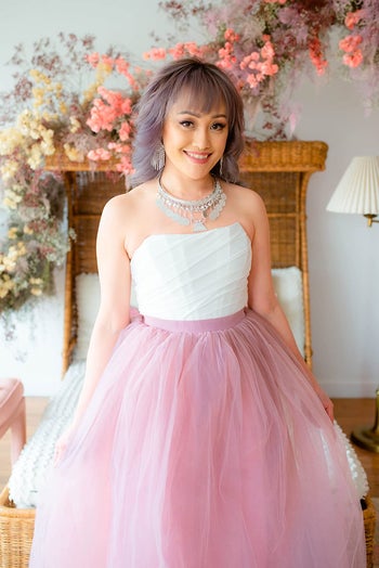 reviewer wearing the bustier in white with pink tulle skirt
