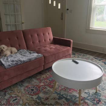 white circular coffee table with three light-wood legs
