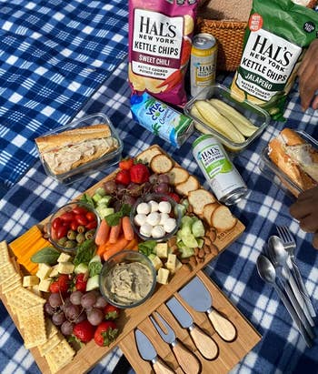 reviewer photo of the charcuterie board filled with vegetables and snacks on a picnic blanket