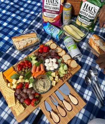reviewer photo of the charcuterie board filled with vegetables and snacks on a picnic blanket