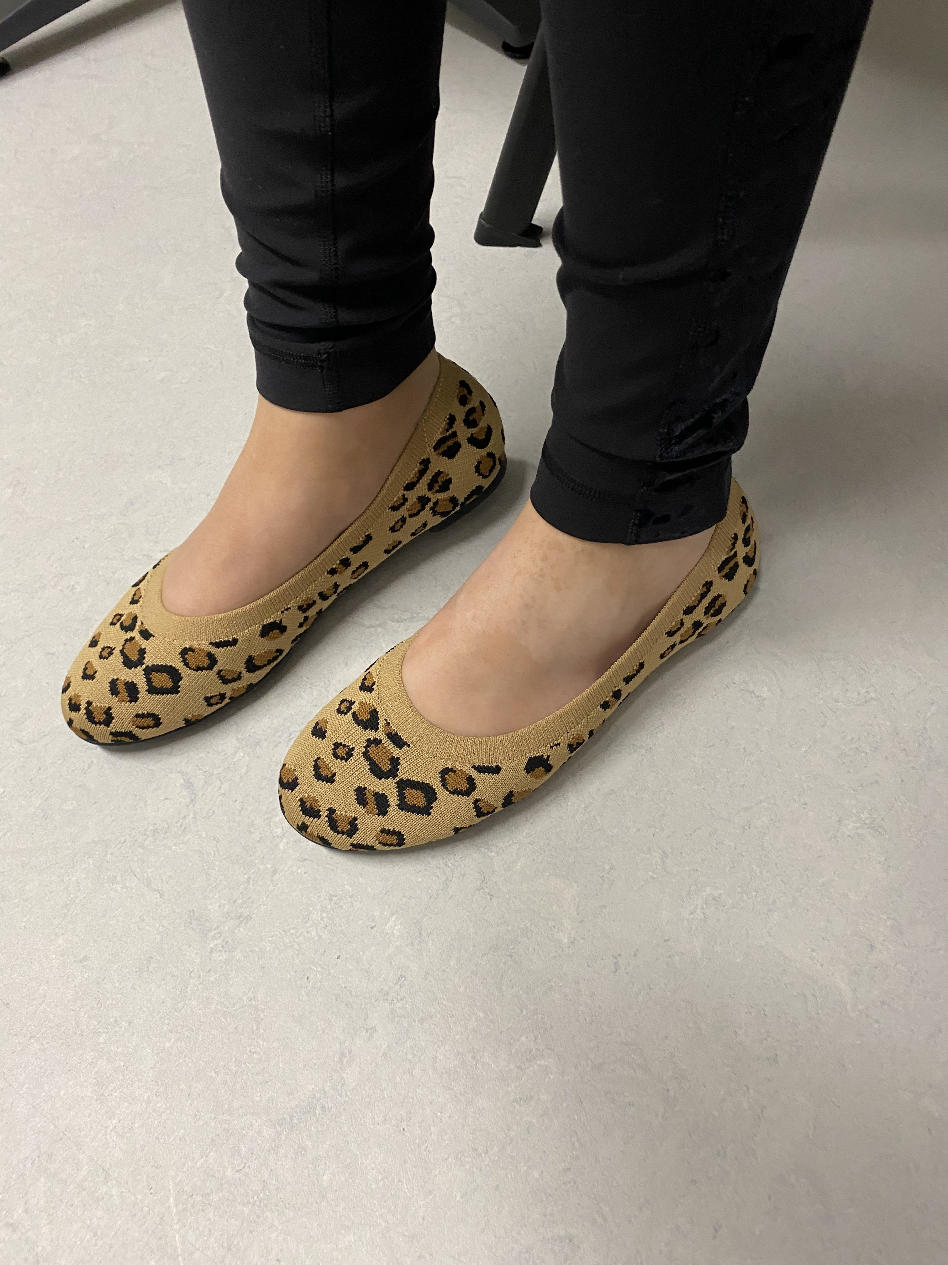 Person wearing leopard people     flats with achromatic  pants