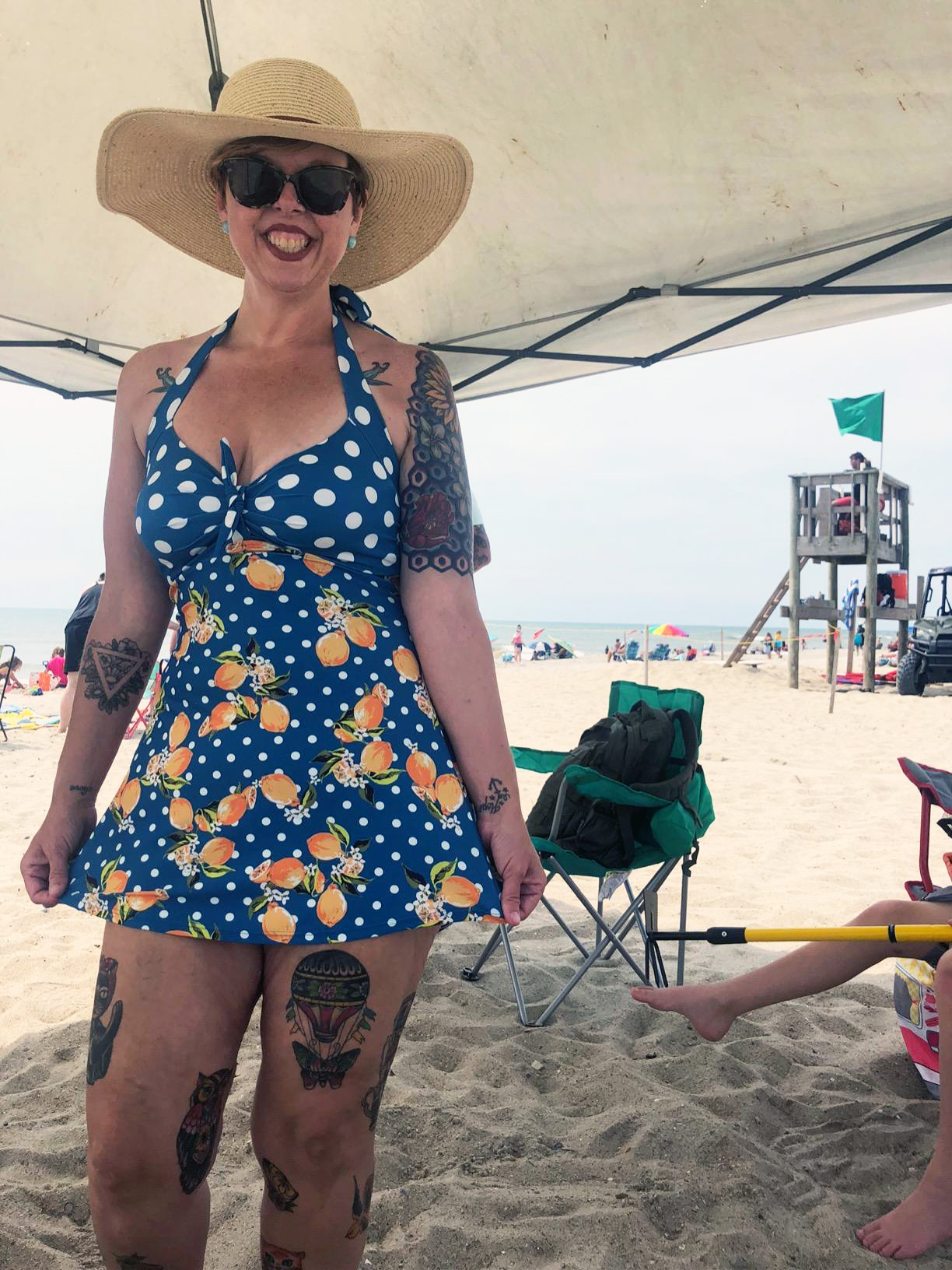 reviewer wearing the blue swimsuit with lemons on it