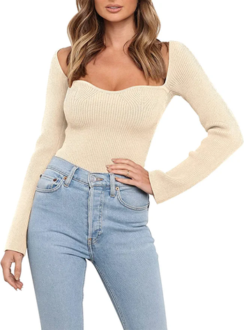 Model in off white knit long sleeved top with sweetheart neckline