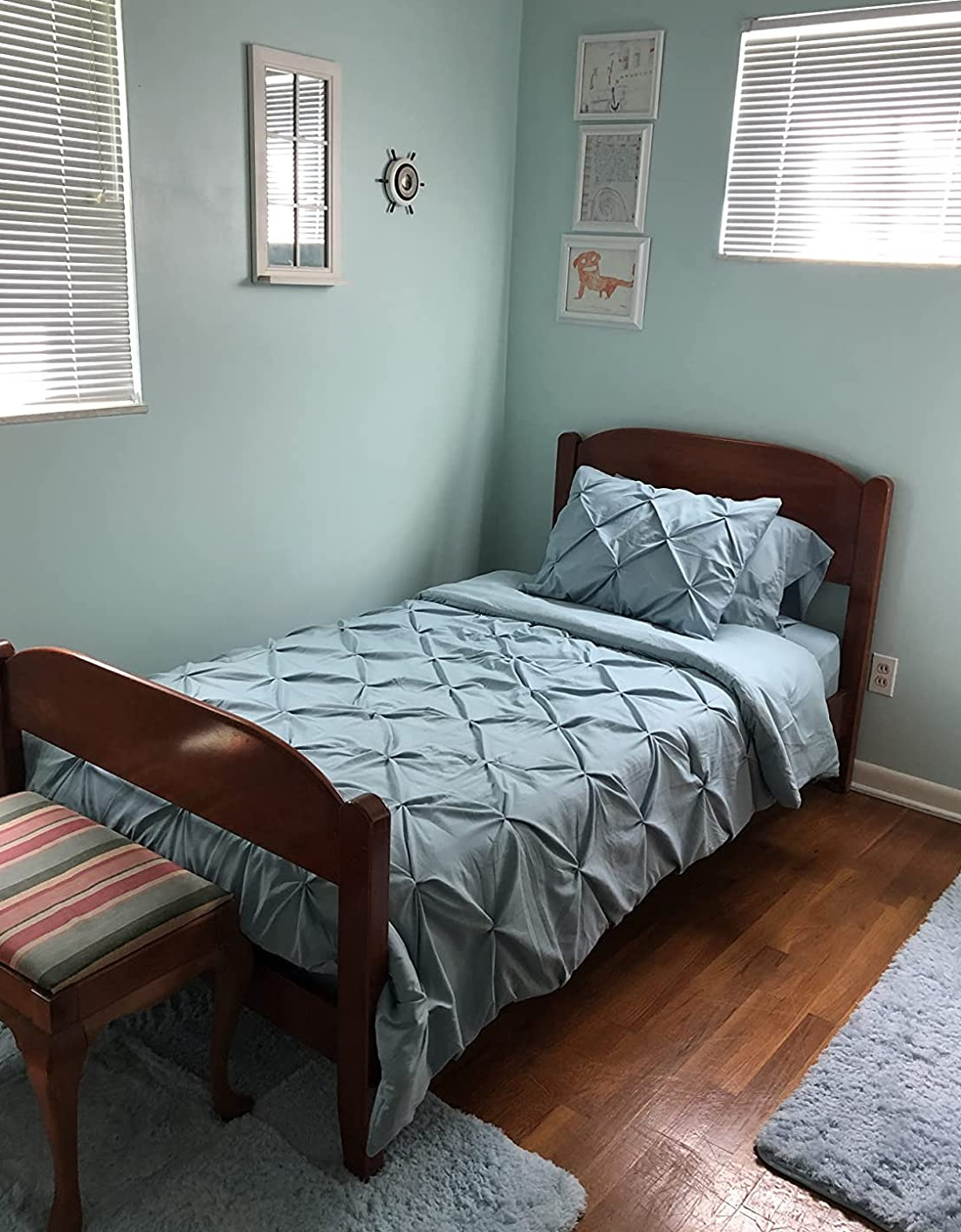 Reviewer image of teal pleated twin-size comforter set with matching sham on a dark wooden bed frame