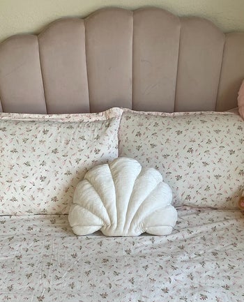 reviewer's white shell pillow on a bed