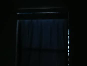 Dimly lit model   with curtains drawn, suggesting a dark, ambient atmosphere