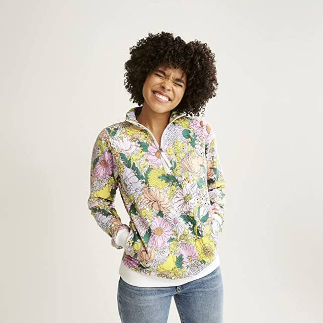 model wearing the pink and yellow floral quarter zip