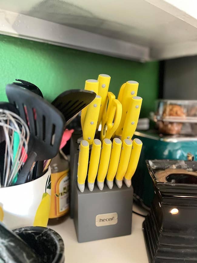 a knife block filled with yellow knives
