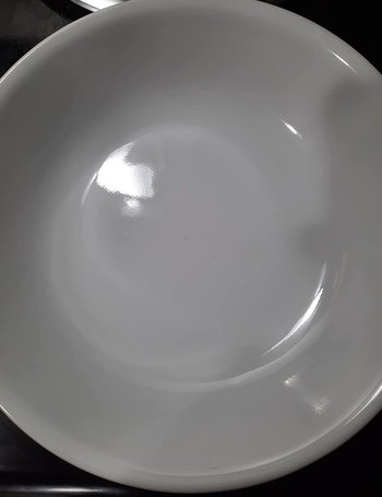 same white bowl looking spotless after being cleaned with the detergent pods
