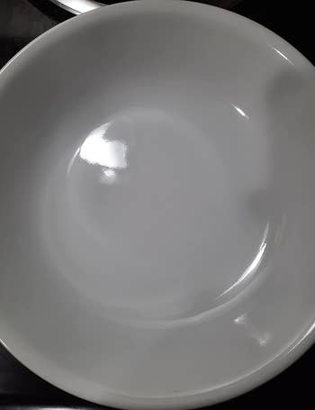 same white bowl looking spotless after being cleaned with the detergent pods