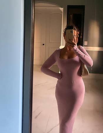 reviewer taking picture in a mirror in light pink dress