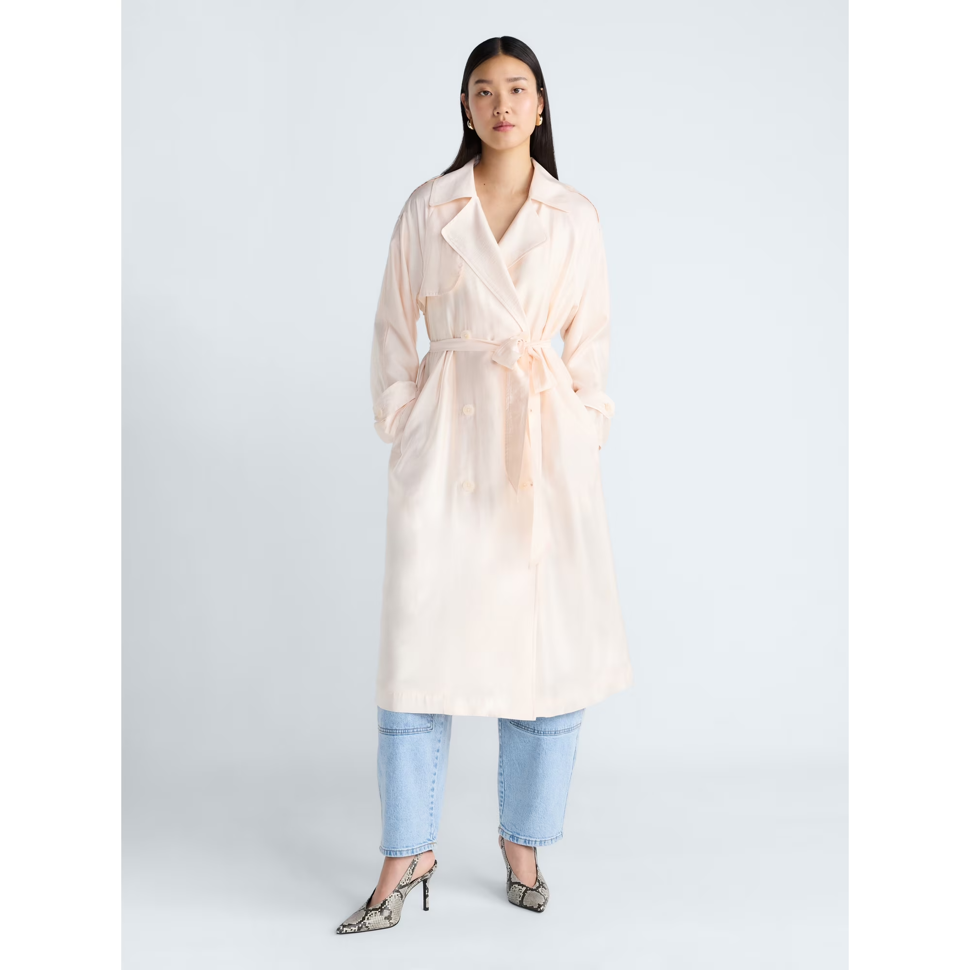 A exemplary  wearing the double-breasted trench overgarment  implicit    jeans and heels
