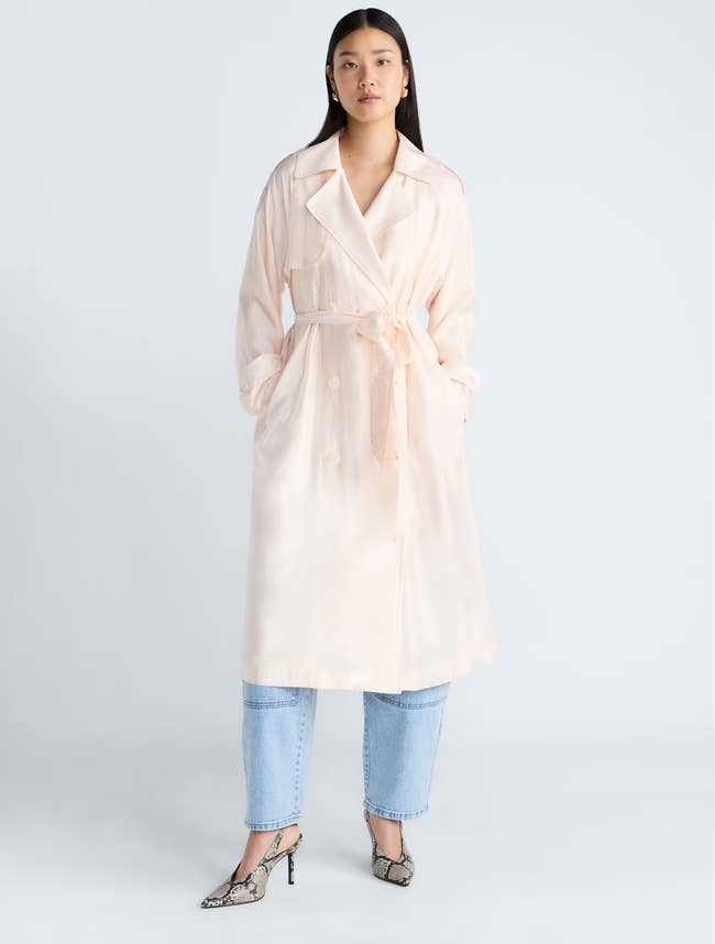 A exemplary wearing the double-breasted trench overgarment implicit jeans and heels