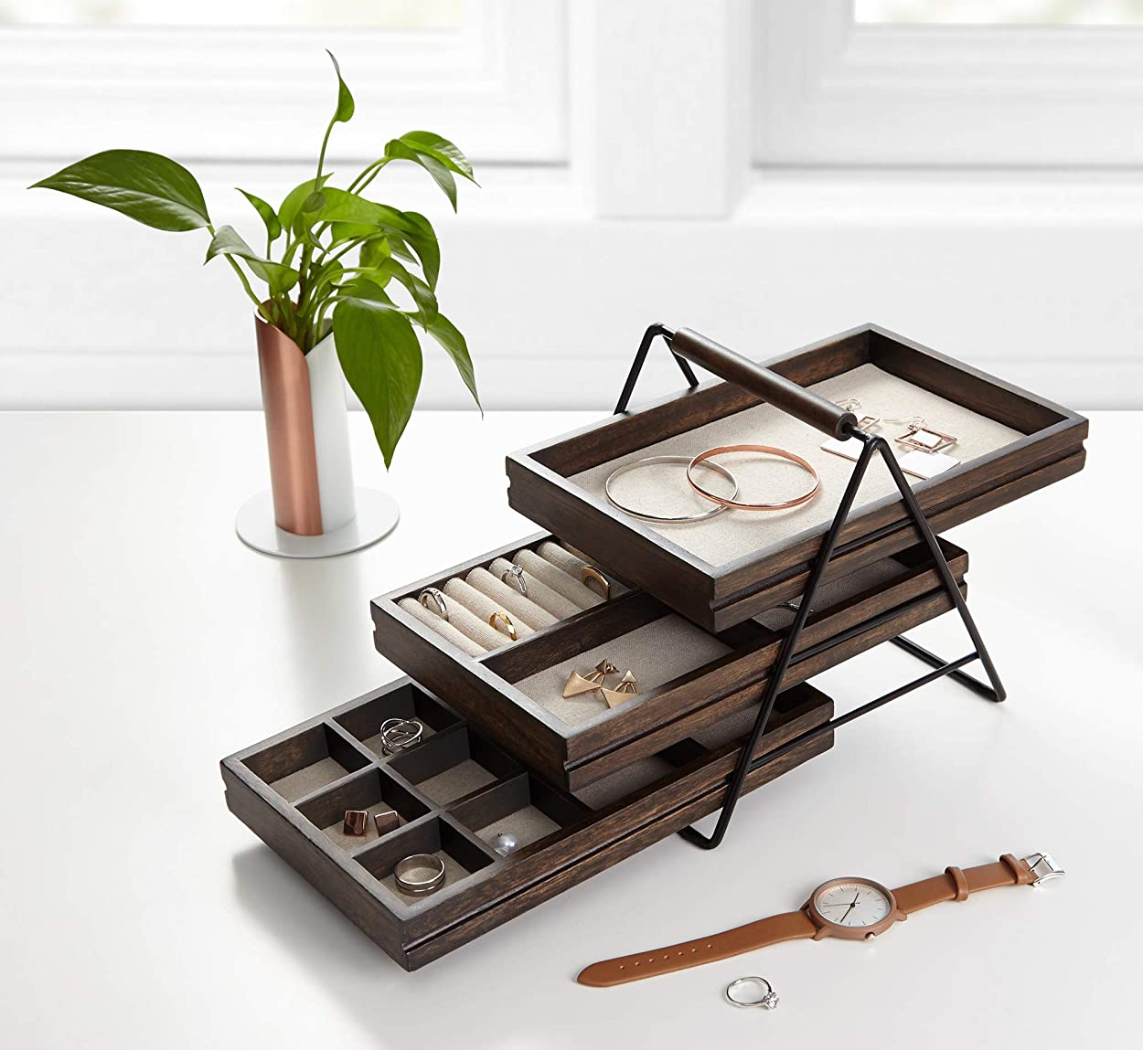 three tier jewelry tray holding several accessories