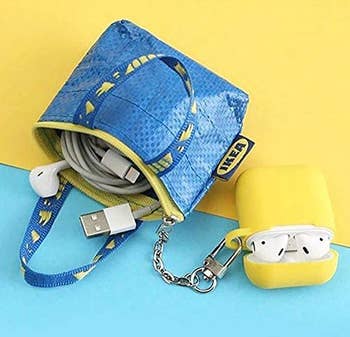 Ikea blue bag purse holding a cable and attached to airpods