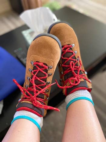 Tan hiking boots with red shoe laces