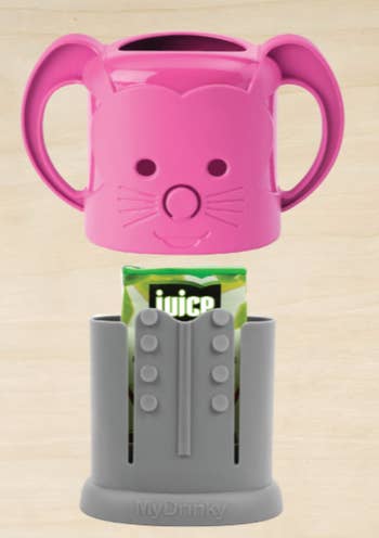 The pink juice lid above the base with a juice box in it