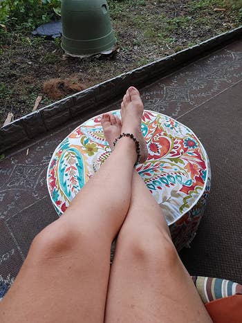 Same reviewer with feet resting on ottoman