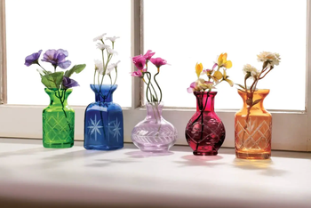 Five small glass vases in different sizes with etching on the bases in green, blue, purples, red, and orange