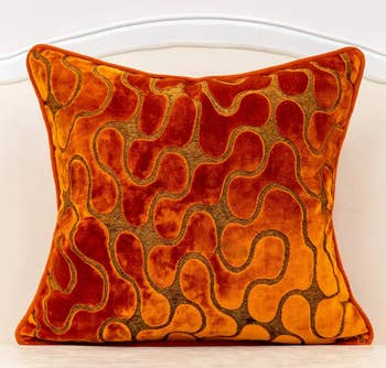 burnt orange velvet cover on a throw pillow
