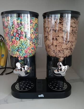 reviewer pic of the black cereal dispenser holding two types of cereal
