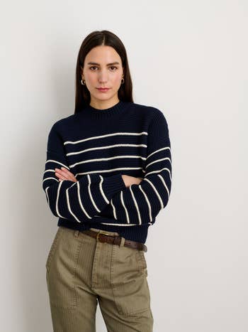 model wearing the sweater with the buttons in the back so it looks like a sweater