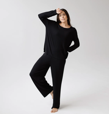 a model wearing the pants in black with a long sleeve t-shirt