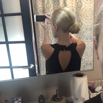 Reviewer with bun aft  wearing the pins