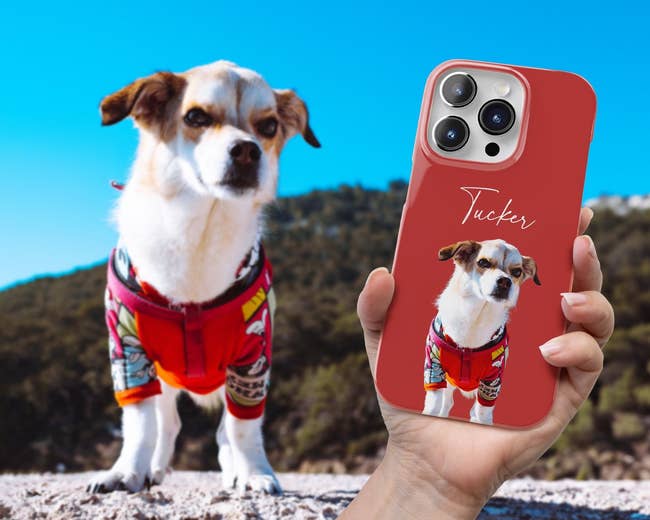 model holding phone in a red case with dog on it and the actual dog in the background