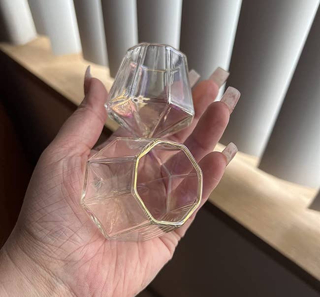 reviewer holding the clear glasses