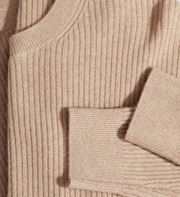 a close up photo of the sweater showing the ribbed texture