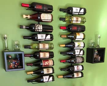 Reviewer image of the black wall-mounted rack with bottles