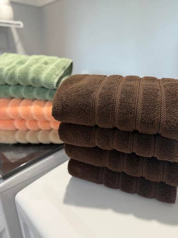Stacked towels successful  antithetic  colors connected  a washing machine