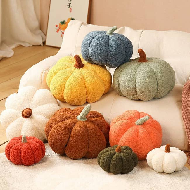 a pile of pumkin pillows in various sizes and colors