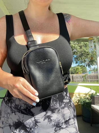 close-up of another reviewer wearing a black crossbody bag