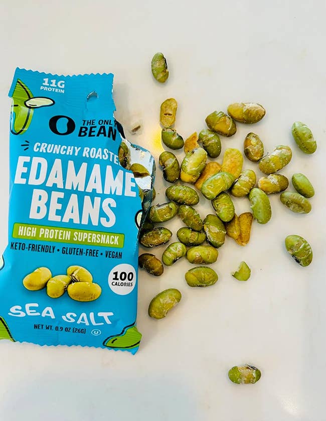 Spilled earn of Crunchy Roasted Edamame Beans on a floor, with contents scattered