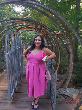 reviewer wearing the dress in rose red