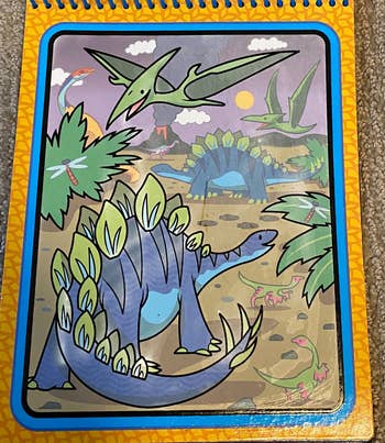 A water activated coloring book with a colored-in image of a dinosaur