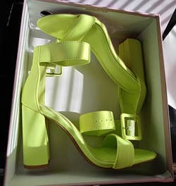 reviewer photo of the green heels in their box